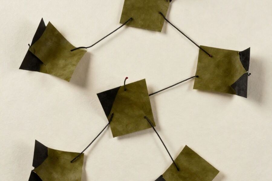 Five paper forms arranged around a central form, joined by taut thread