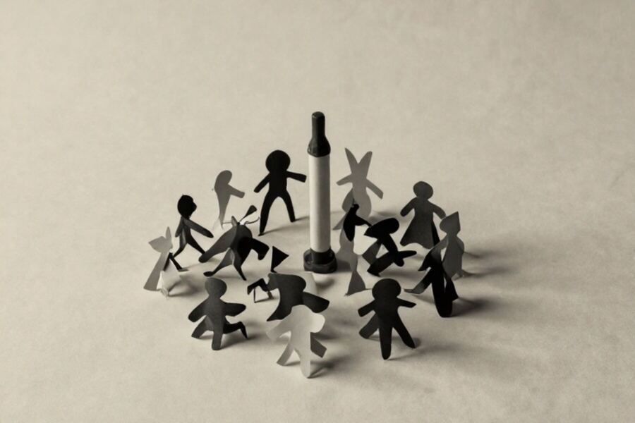 A cluster of small paper forms gathered around one taller marker