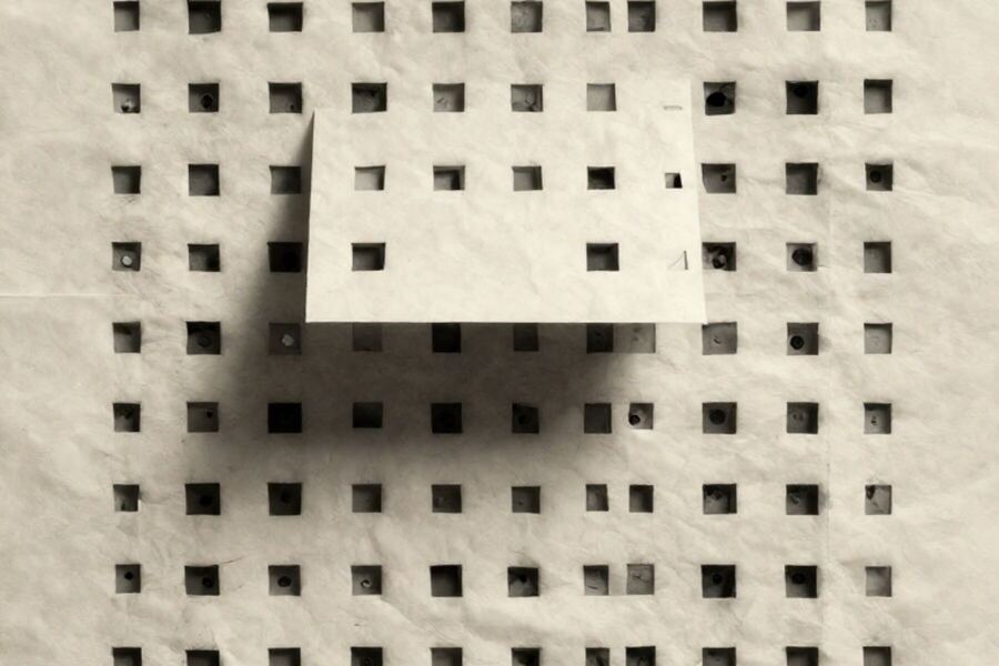 A rigid grid of paper cells with one cell lifted forward