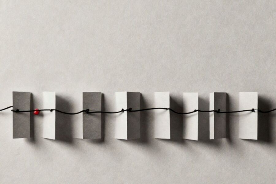 A row of identical paper markers threaded onto a single taut line